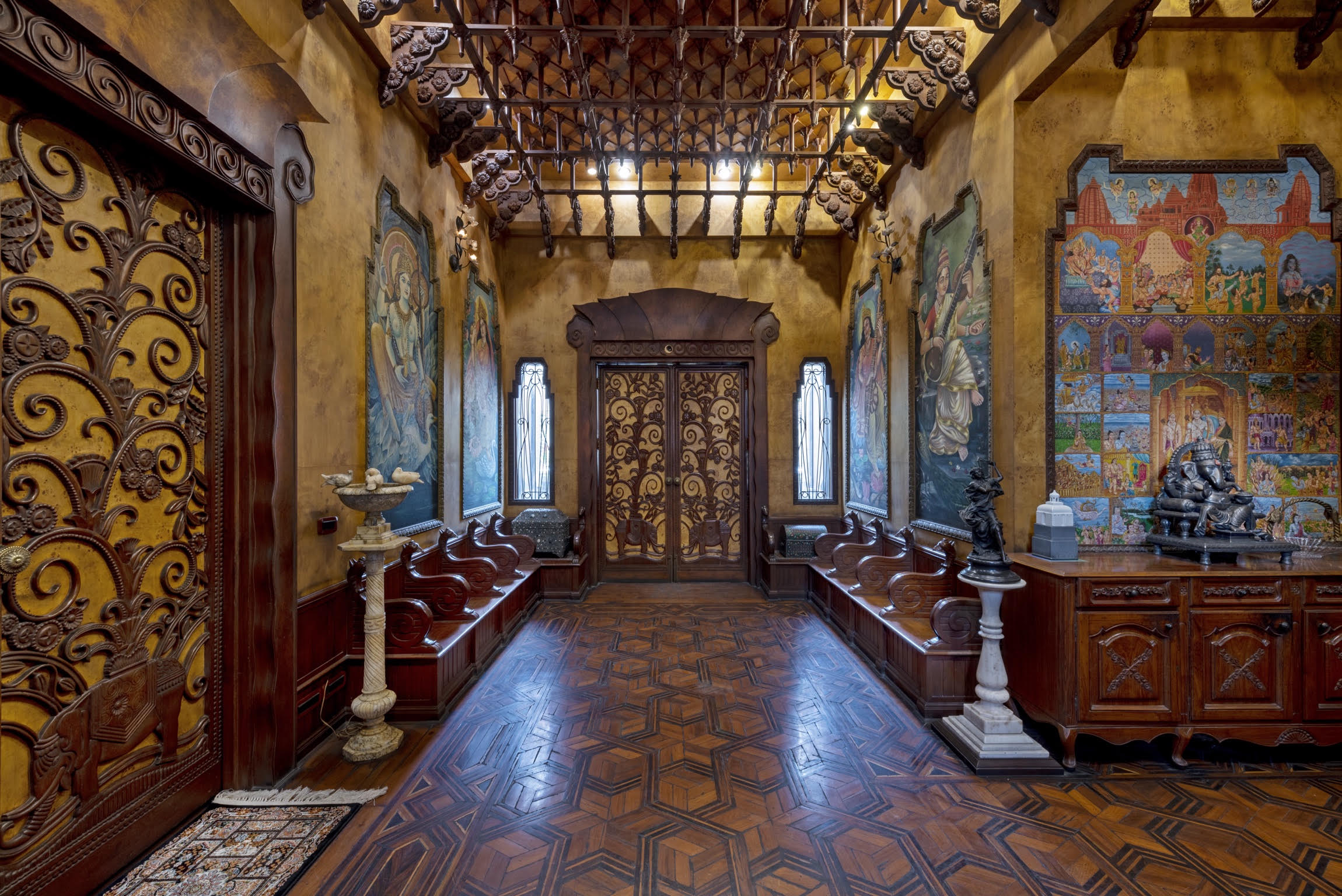 Carved Art Nouveau doors, murals and a parquet floor in the entrance hall