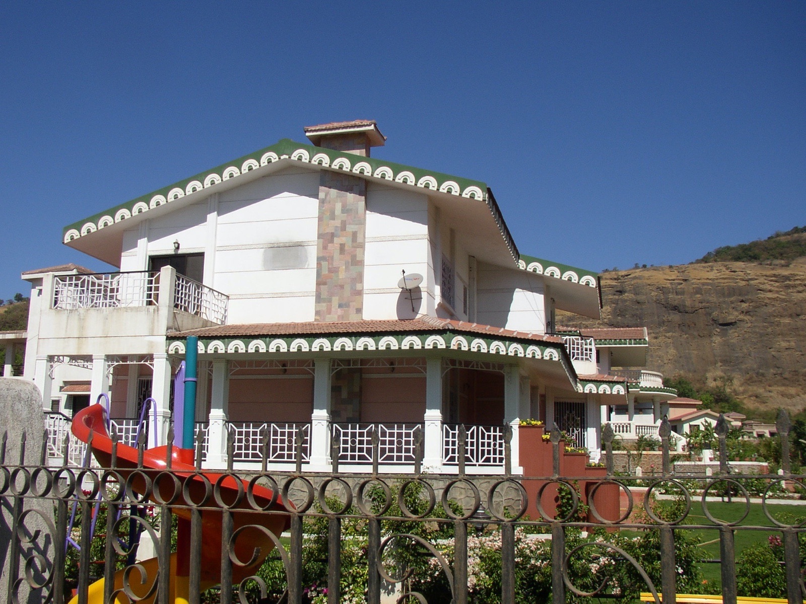 A Valley Queen Estates bungalow with scalloped eaves and a stone chimney