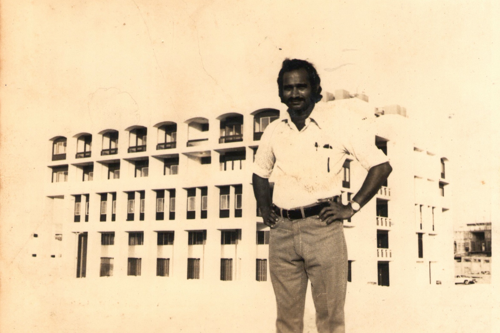 Architect Liladhar Dinkar Dudwadkar in front of one of his buildings